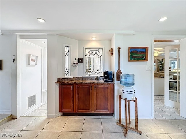 bar featuring light tile patterned flooring, a sink, visible vents, and recessed lighting