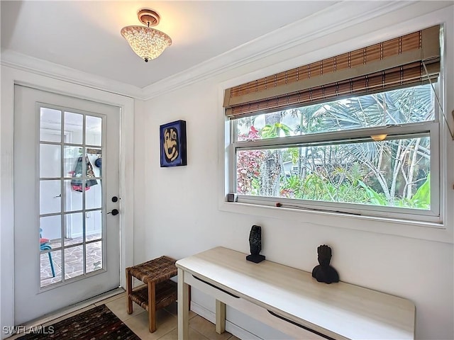 doorway to outside featuring light tile patterned floors and crown molding