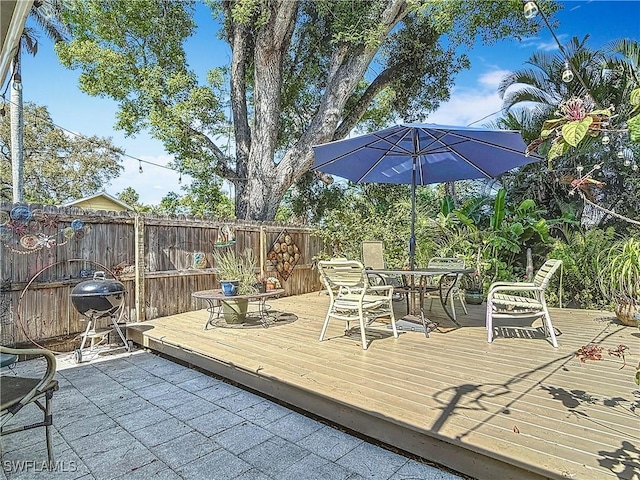 wooden deck featuring outdoor dining area and fence