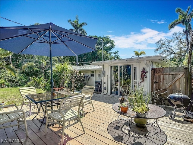 wooden deck featuring outdoor dining area