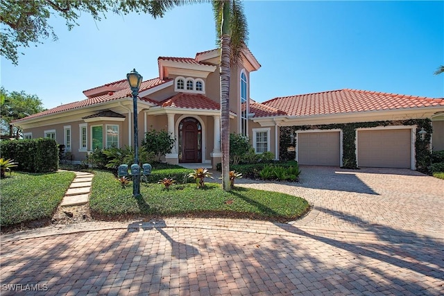 mediterranean / spanish-style house with a garage