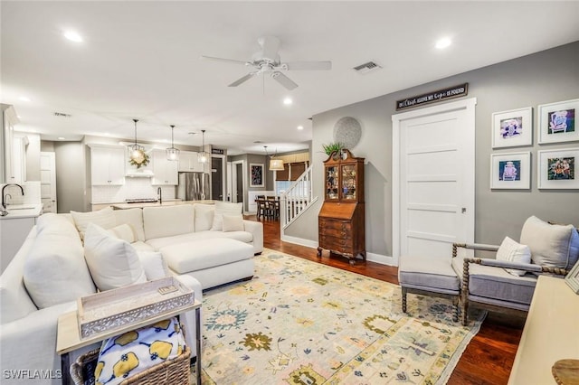 living area featuring stairway, wood finished floors, visible vents, and recessed lighting