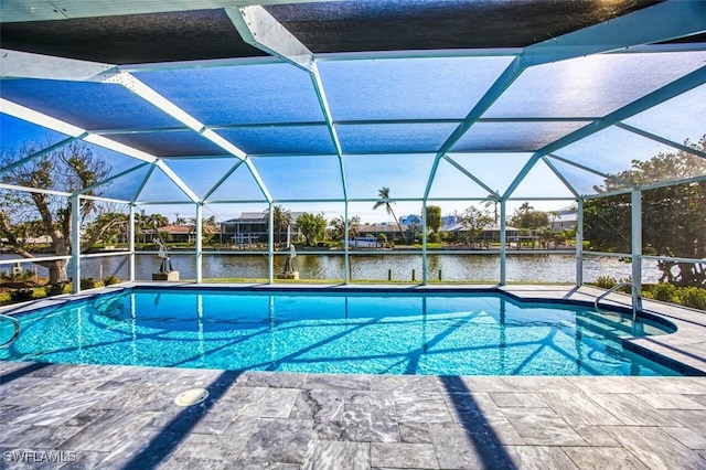 view of swimming pool with a patio area, a water view, and glass enclosure