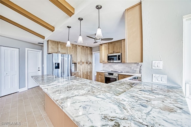 kitchen featuring kitchen peninsula, hanging light fixtures, sink, tasteful backsplash, and appliances with stainless steel finishes