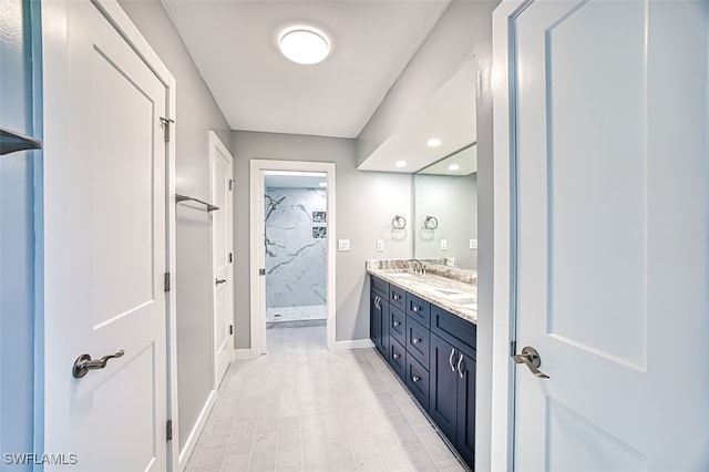 bathroom featuring vanity and tiled shower