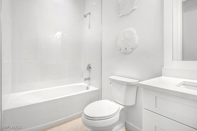 full bathroom featuring vanity, tiled shower / bath, and toilet