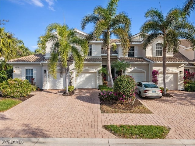 mediterranean / spanish home featuring a garage