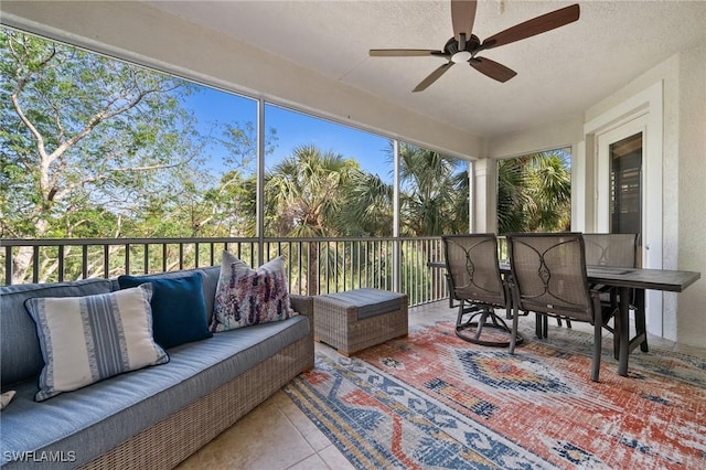 sunroom / solarium featuring ceiling fan