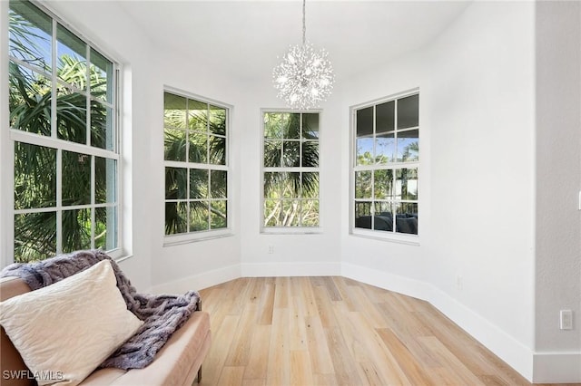 unfurnished sunroom featuring a wealth of natural light and a notable chandelier