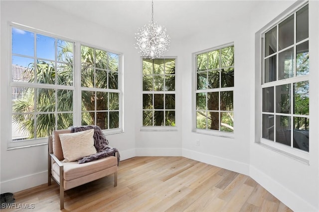 sunroom / solarium with a chandelier