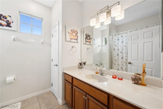 bathroom with tile patterned floors, a wealth of natural light, vanity, and toilet