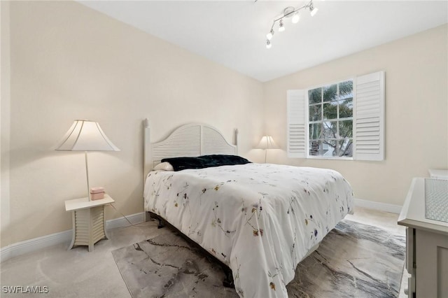 bedroom featuring carpet and track lighting