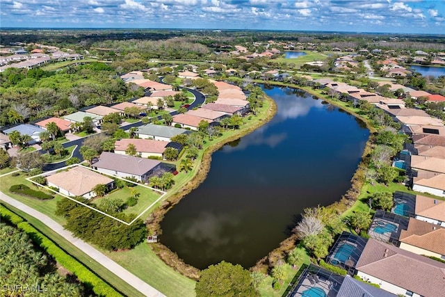 drone / aerial view featuring a residential view and a water view