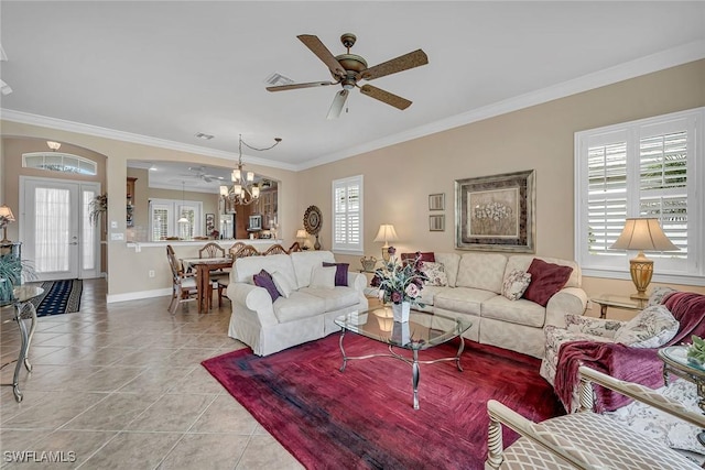 living area with ornamental molding, light tile patterned flooring, and ceiling fan with notable chandelier