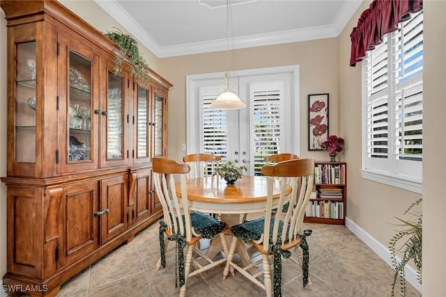 dining space featuring baseboards, ornamental molding, and a wealth of natural light