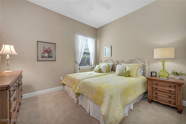 bedroom with baseboards, ceiling fan, and light colored carpet