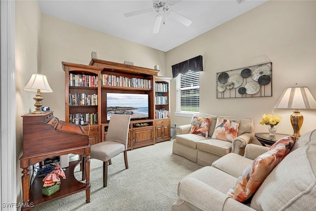 carpeted living area featuring a ceiling fan