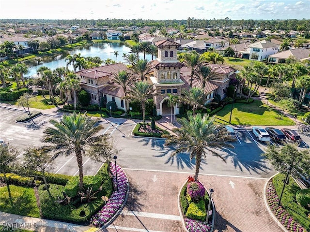 birds eye view of property with a water view and a residential view