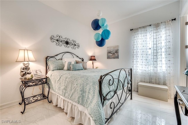 bedroom featuring marble finish floor