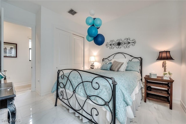 bedroom with marble finish floor, visible vents, and baseboards