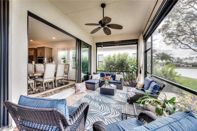 sunroom featuring a ceiling fan