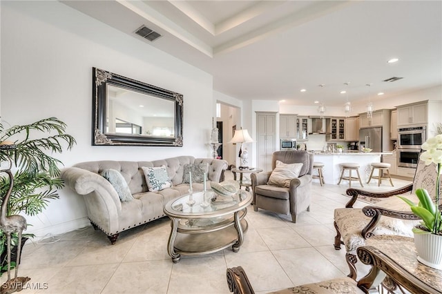 living room with recessed lighting, visible vents, and light tile patterned floors