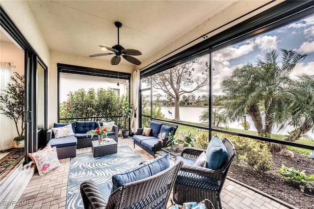 sunroom featuring ceiling fan