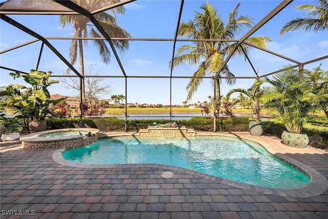 view of pool with an in ground hot tub, glass enclosure, a patio, and a water view