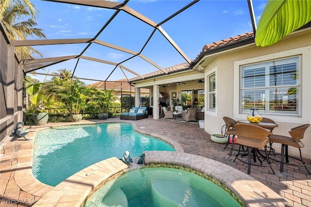 view of swimming pool with a patio, an in ground hot tub, a lanai, ceiling fan, and an outdoor living space