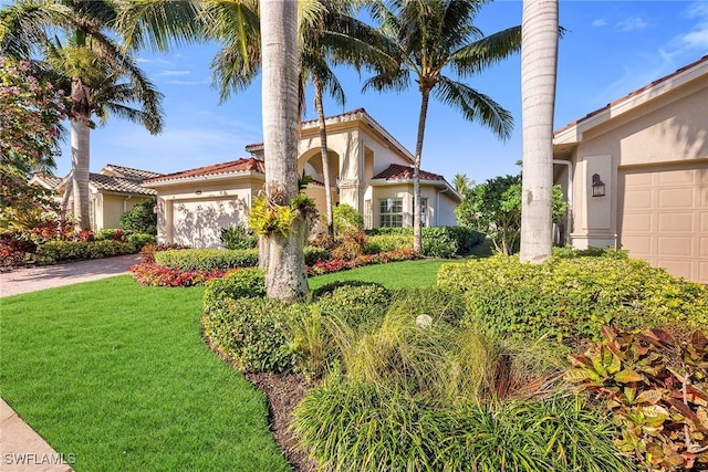 view of front of home with a front lawn and a garage