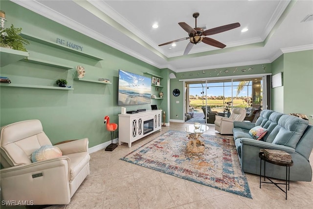 tiled living room with a tray ceiling, crown molding, and ceiling fan