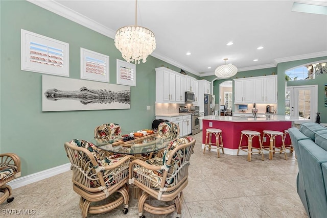 dining area featuring french doors, crown molding, a notable chandelier, and sink