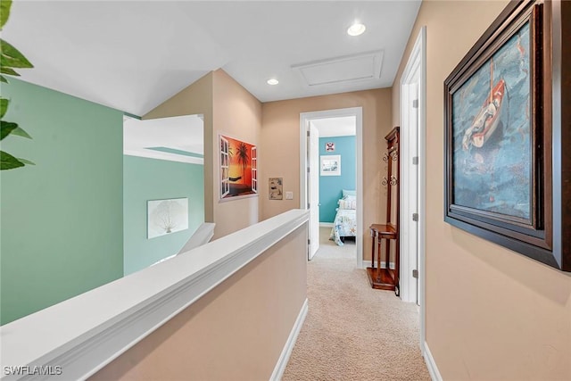 hallway featuring light colored carpet