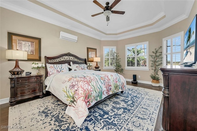 bedroom with a wall mounted air conditioner, a tray ceiling, ornamental molding, ceiling fan, and hardwood / wood-style floors