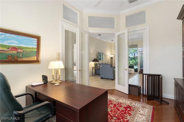 office with baseboards, wood finished floors, crown molding, and french doors