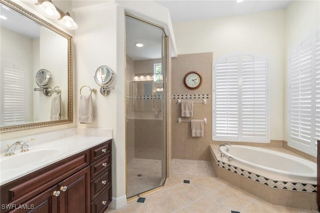 full bathroom with a bath, a shower stall, vanity, and tile patterned floors