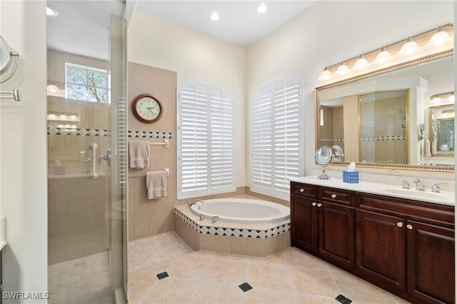 bathroom featuring a stall shower, a garden tub, vanity, and tile patterned floors