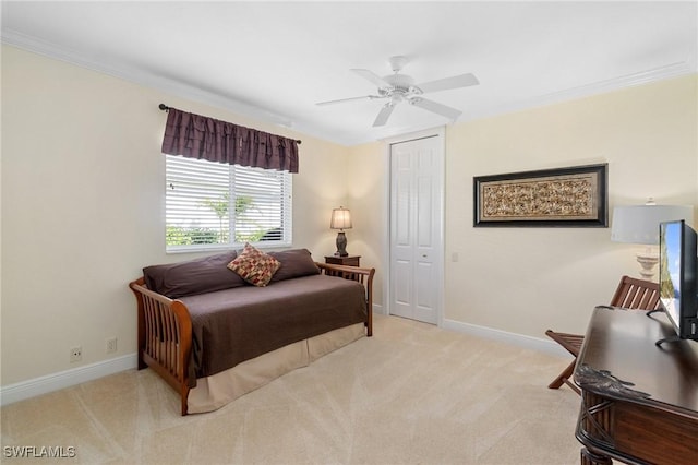 bedroom with light carpet, baseboards, and crown molding