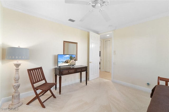 sitting room with baseboards, visible vents, light colored carpet, ceiling fan, and crown molding