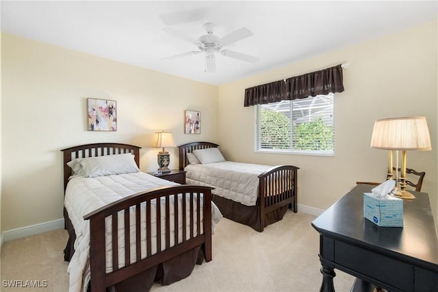 bedroom with ceiling fan, carpet, and baseboards