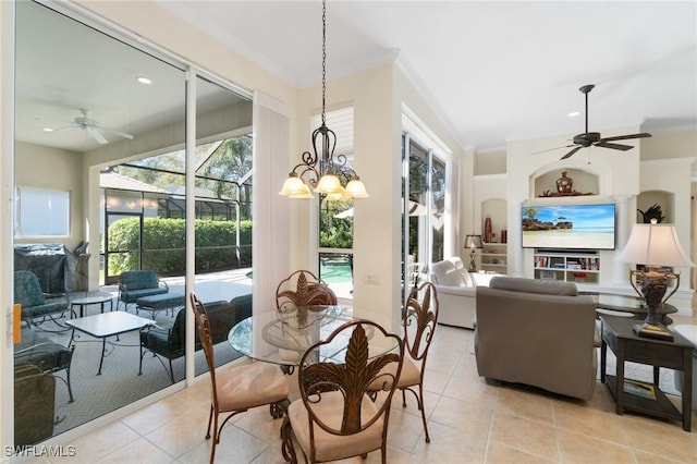 dining area featuring built in shelves, light tile patterned floors, ornamental molding, a ceiling fan, and a sunroom