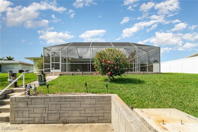 view of yard featuring glass enclosure and fence