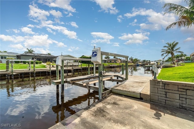 dock area with a water view and boat lift