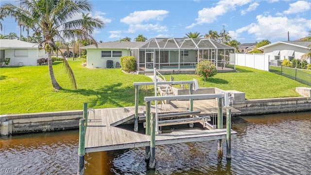 view of dock with a yard, glass enclosure, a water view, and boat lift