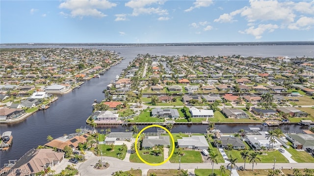 bird's eye view featuring a water view and a residential view