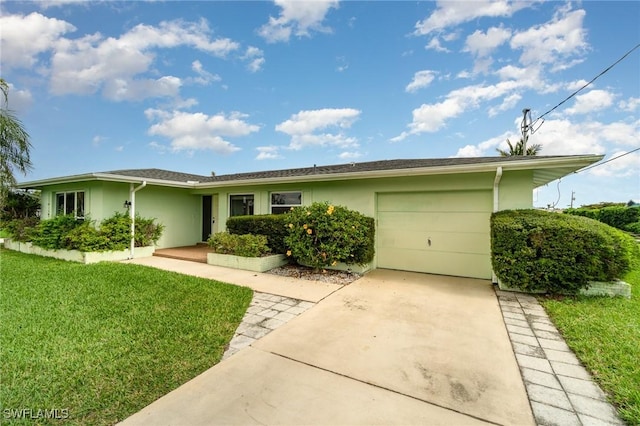 ranch-style house with a garage, concrete driveway, a front lawn, and stucco siding