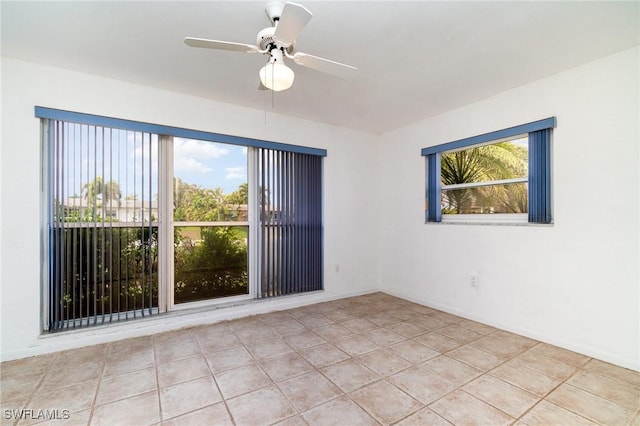 unfurnished room with light tile patterned floors and a ceiling fan