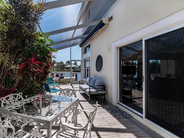 view of patio / terrace with a water view and an outdoor living space