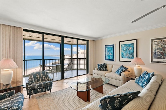 living room featuring light tile patterned floors, ornamental molding, a water view, and floor to ceiling windows