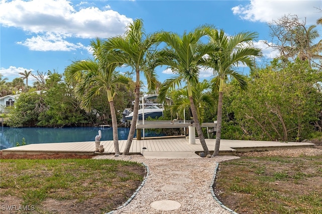 view of property's community with a water view and a boat dock